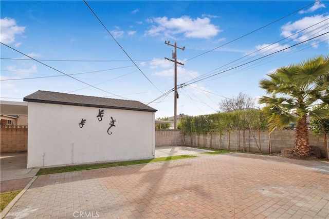 view of outbuilding with fence