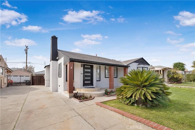 view of front of home featuring a front lawn, a chimney, and fence