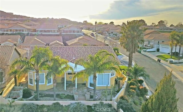 aerial view at dusk featuring a residential view