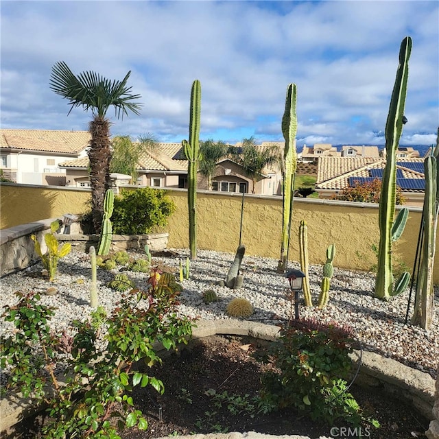view of yard featuring fence and a residential view