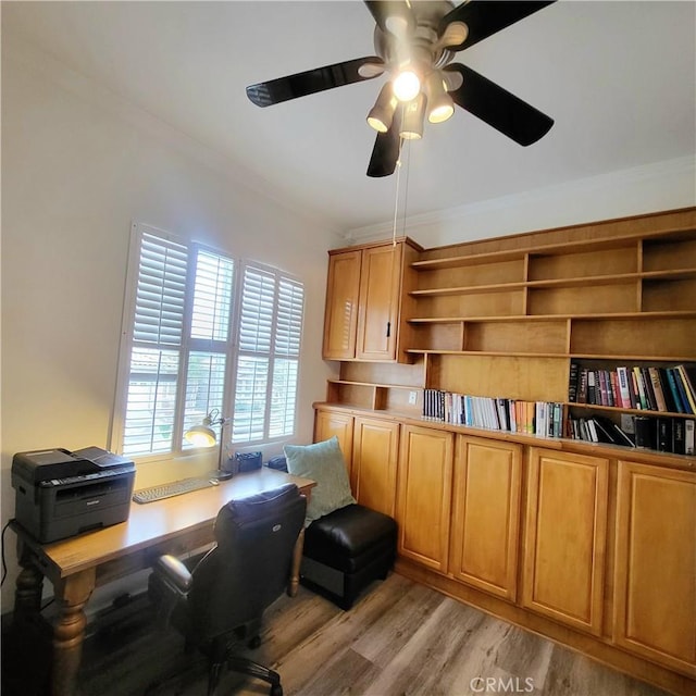office space with light wood-style flooring, crown molding, and ceiling fan