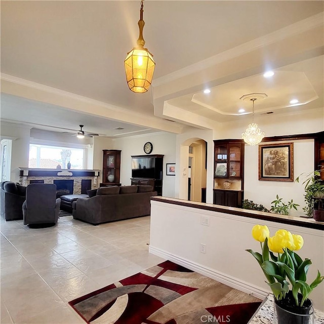 interior space with arched walkways and ceiling fan with notable chandelier