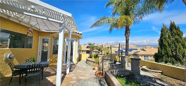 view of patio with fence, a residential view, and a pergola