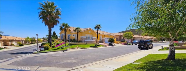 view of street with a residential view, curbs, and sidewalks