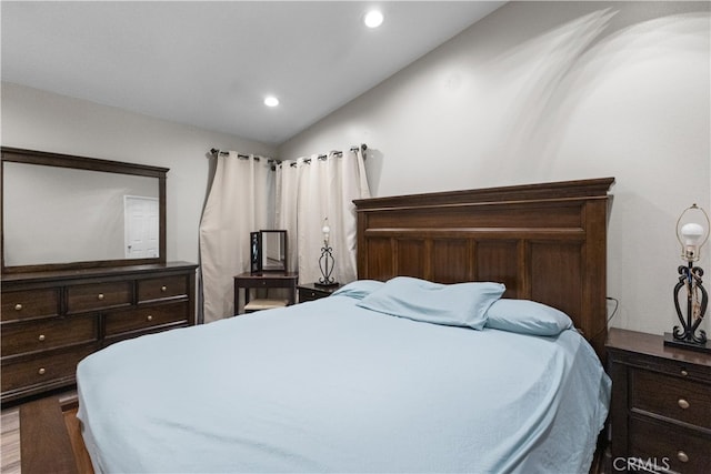 bedroom featuring vaulted ceiling, wood finished floors, and recessed lighting