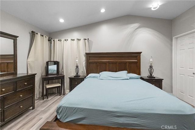 bedroom with recessed lighting, light wood-style flooring, and vaulted ceiling