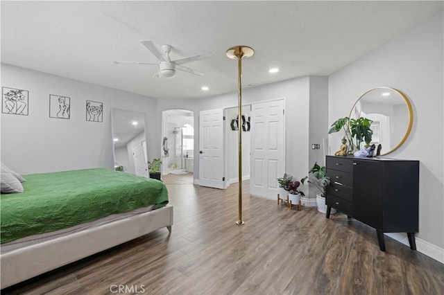 bedroom with recessed lighting, baseboards, arched walkways, and wood finished floors