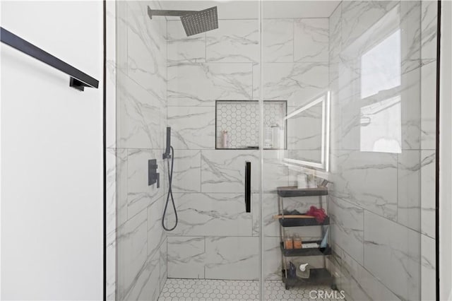 bathroom featuring a marble finish shower