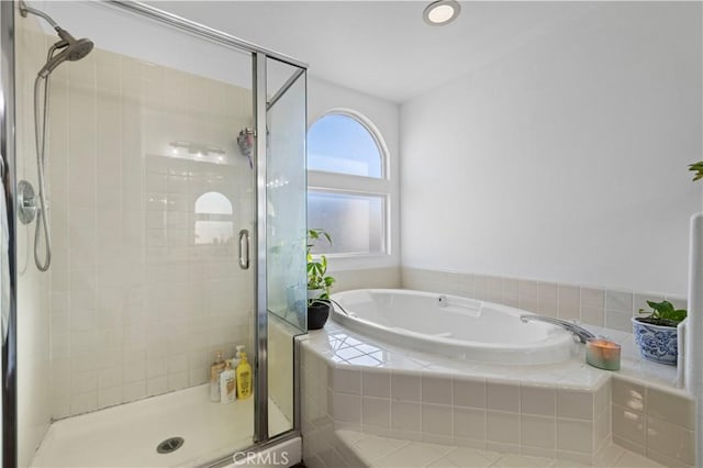 full bath featuring a garden tub and a stall shower