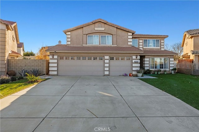 traditional-style house featuring fence, an attached garage, stucco siding, concrete driveway, and a tiled roof