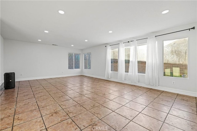 unfurnished room featuring light tile patterned floors, recessed lighting, and baseboards