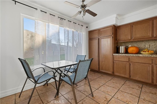 dining area featuring light tile patterned floors, a wealth of natural light, and ceiling fan