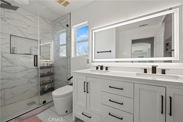 bathroom with visible vents, marble finish floor, and a sink