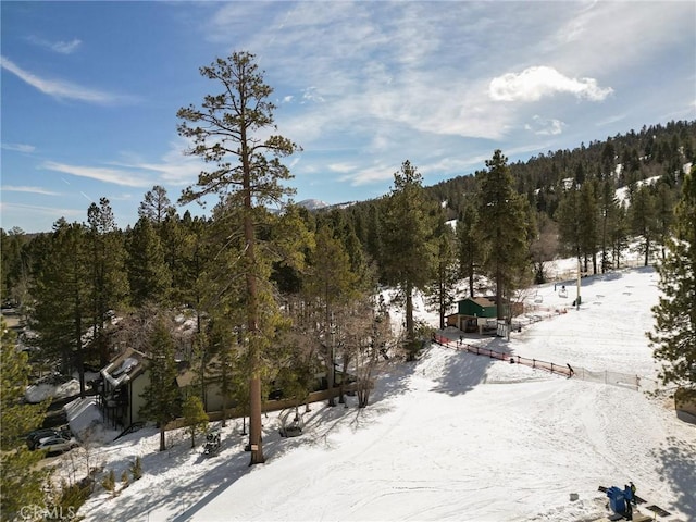 snowy aerial view with a forest view