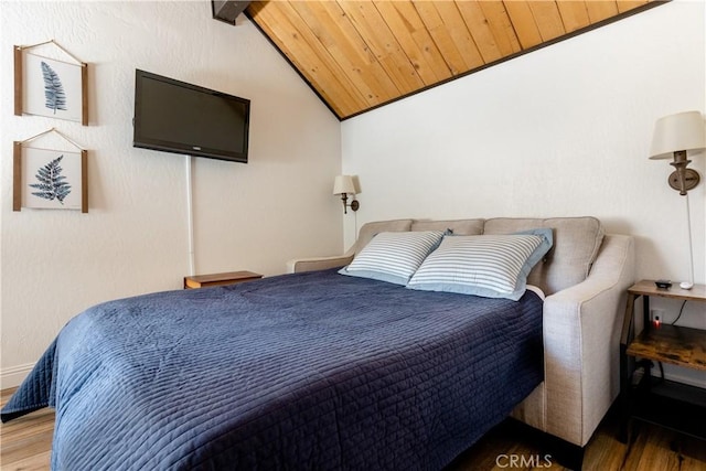 bedroom featuring wooden ceiling, vaulted ceiling with beams, and wood finished floors