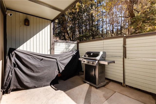 view of patio featuring grilling area and fence