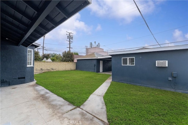 view of yard featuring an outdoor structure, fence, and a patio area