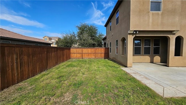 view of yard with a fenced backyard and a patio