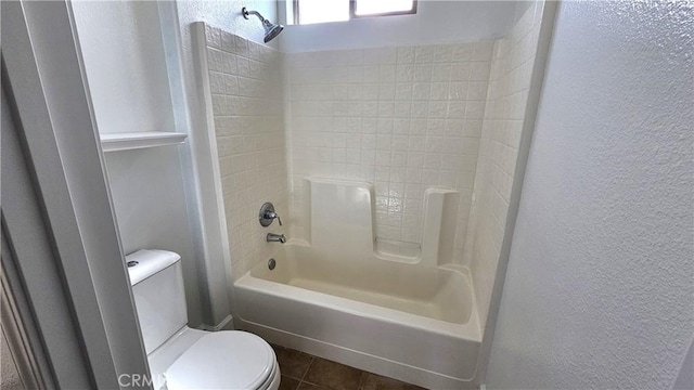 full bathroom featuring tile patterned flooring, shower / tub combination, toilet, and a textured wall