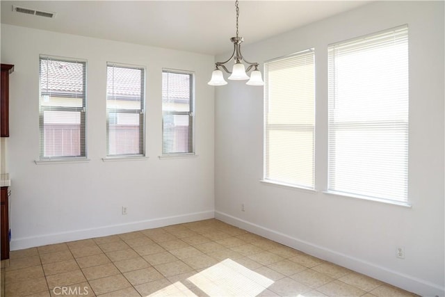 unfurnished dining area featuring visible vents, plenty of natural light, and baseboards