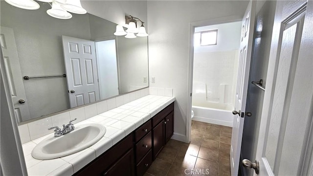 full bath featuring tile patterned flooring, baseboards, toilet, shower / bath combination, and vanity