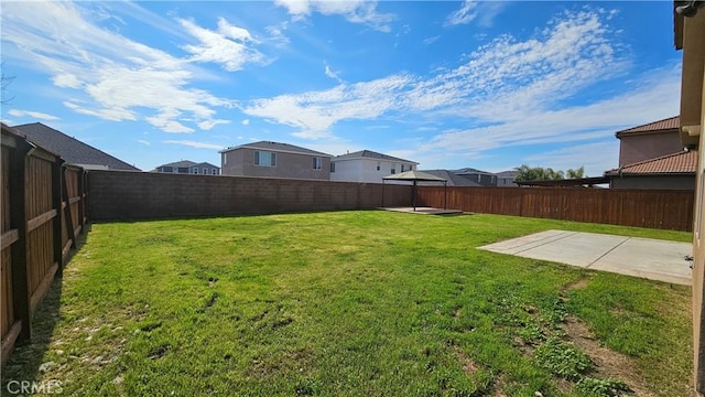 view of yard with a patio area and a fenced backyard