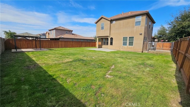 back of property with a gazebo, stucco siding, a fenced backyard, a yard, and a patio