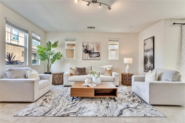 living area featuring carpet and visible vents