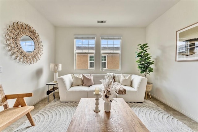 carpeted living room with visible vents and baseboards