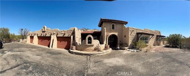 view of front of house featuring an attached garage and stucco siding