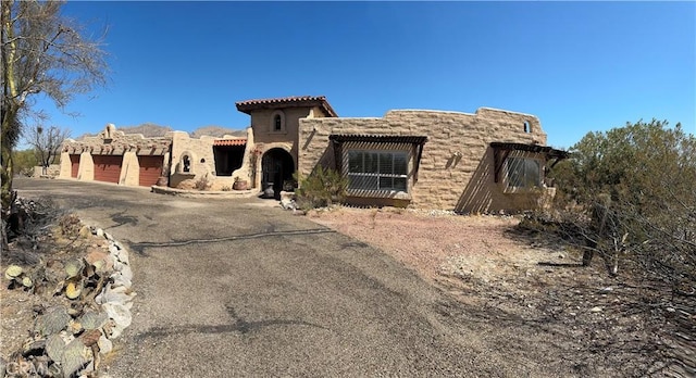 view of front of home with aphalt driveway and an attached garage