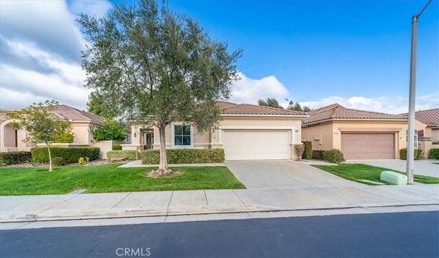 view of front facade featuring a front lawn, a tiled roof, stucco siding, driveway, and an attached garage