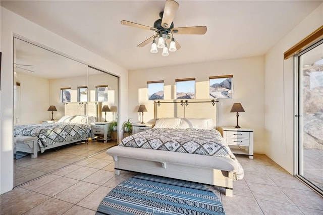 60125 Carrizo Rd, Mountain Center, CA 92561 - bedroom with light tile patterned floors, multiple windows, a ceiling fan, and access to exterior
