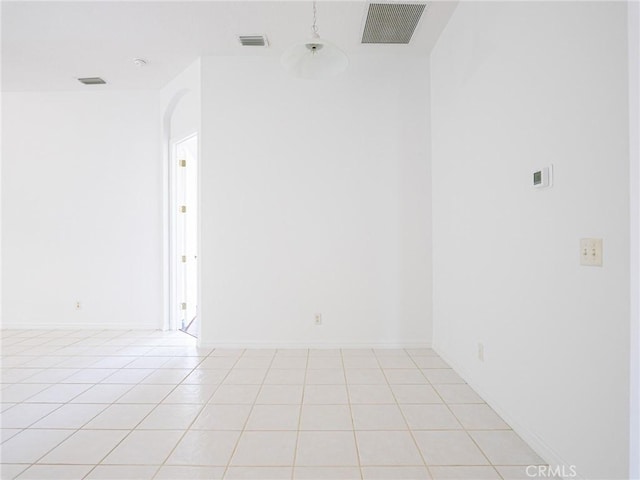 unfurnished room with visible vents, baseboards, and light tile patterned flooring