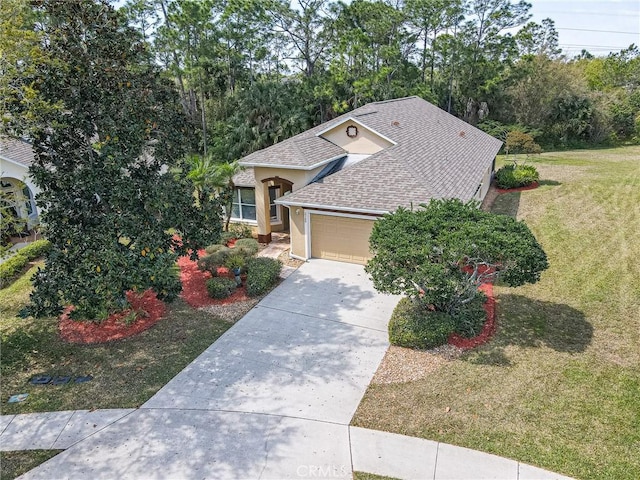 view of front of home with stucco siding, driveway, a front lawn, an attached garage, and a shingled roof