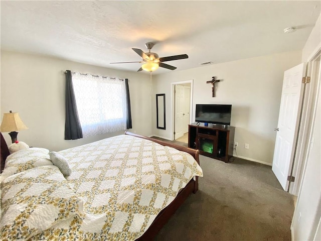 bedroom with visible vents, baseboards, carpet, and a ceiling fan