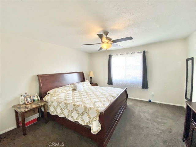 bedroom with dark colored carpet, baseboards, and ceiling fan