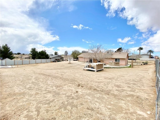 view of yard featuring a wooden deck and fence