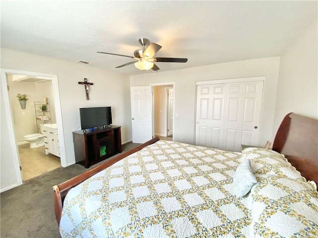 carpeted bedroom with connected bathroom, a closet, and ceiling fan