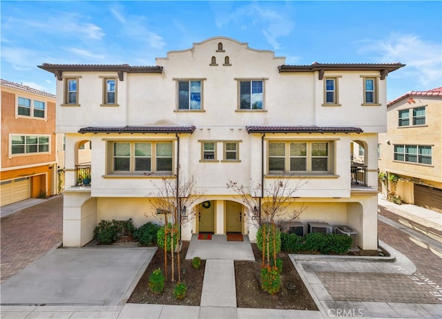 view of front of property with a tiled roof and stucco siding