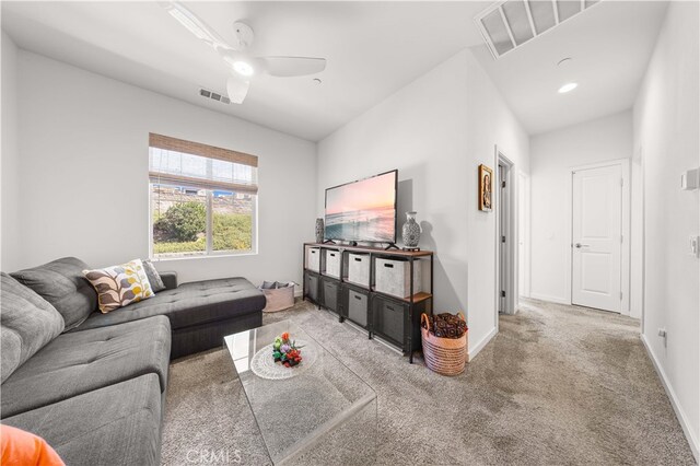 carpeted living area featuring visible vents, ceiling fan, and baseboards