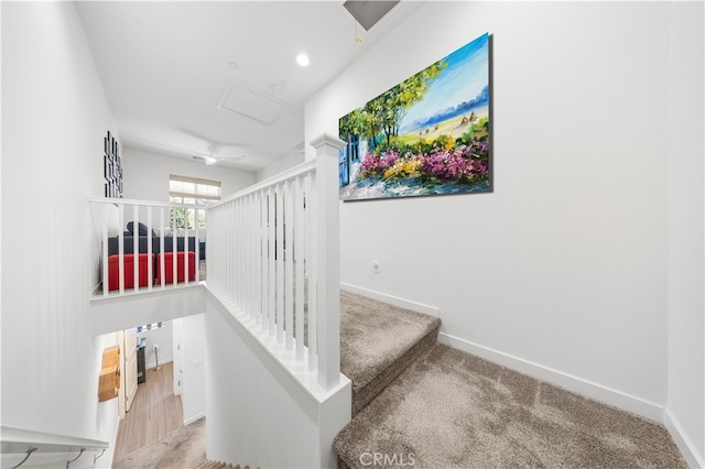 stairs with attic access, carpet flooring, and baseboards