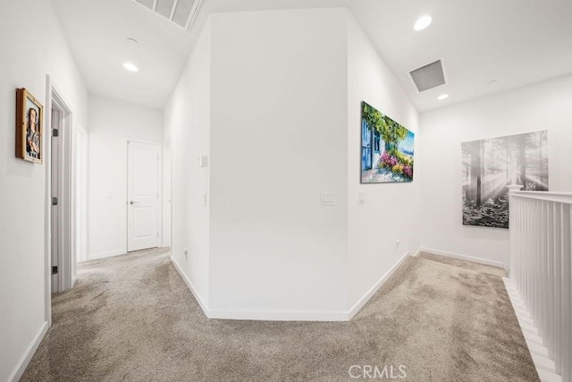 hallway with visible vents, recessed lighting, baseboards, and carpet floors