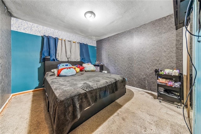 carpeted bedroom with a textured ceiling and baseboards