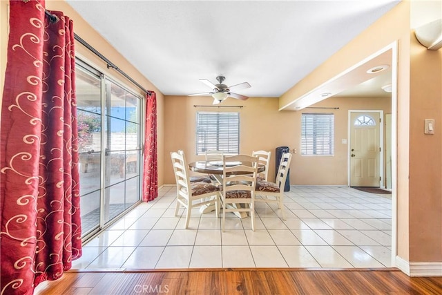 dining area with baseboards, a ceiling fan, and wood finished floors