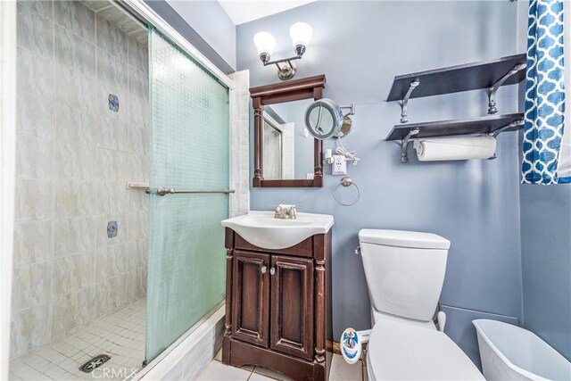 bathroom featuring a stall shower, toilet, and vanity