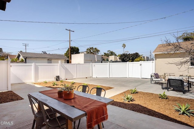 view of patio / terrace featuring outdoor dining space, a gate, and a fenced backyard