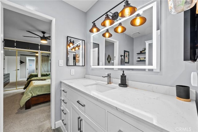 bathroom with ensuite bath, ceiling fan, and vanity