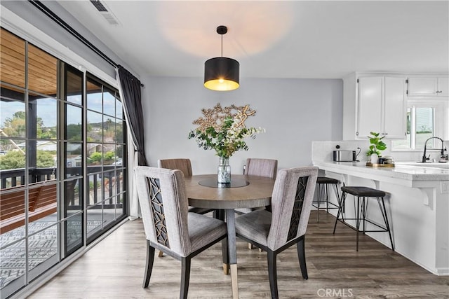 dining room with visible vents and light wood-type flooring