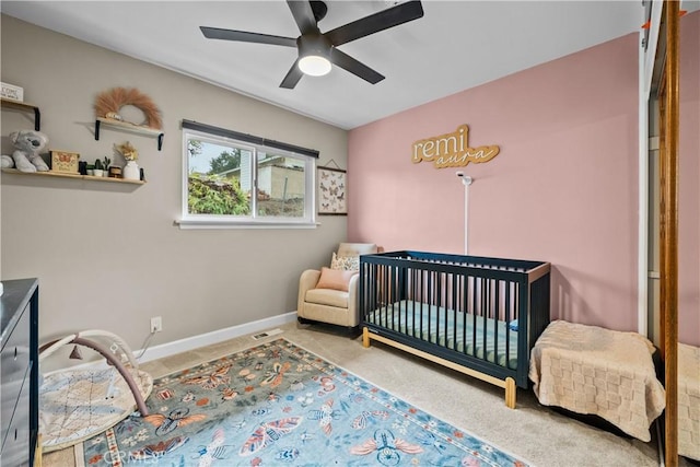 bedroom with a ceiling fan, carpet, and baseboards